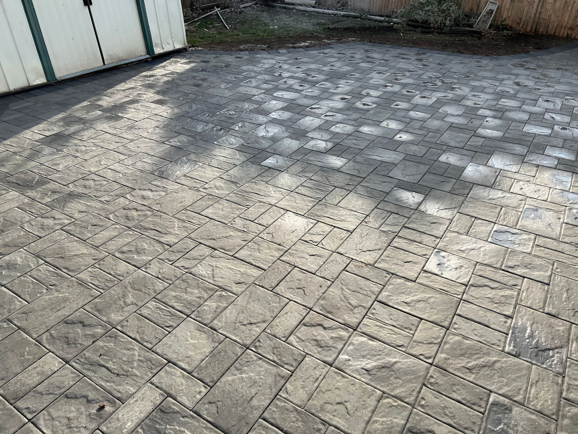 Slate-tone paver patio with charcoal border — Holbrook, NY
