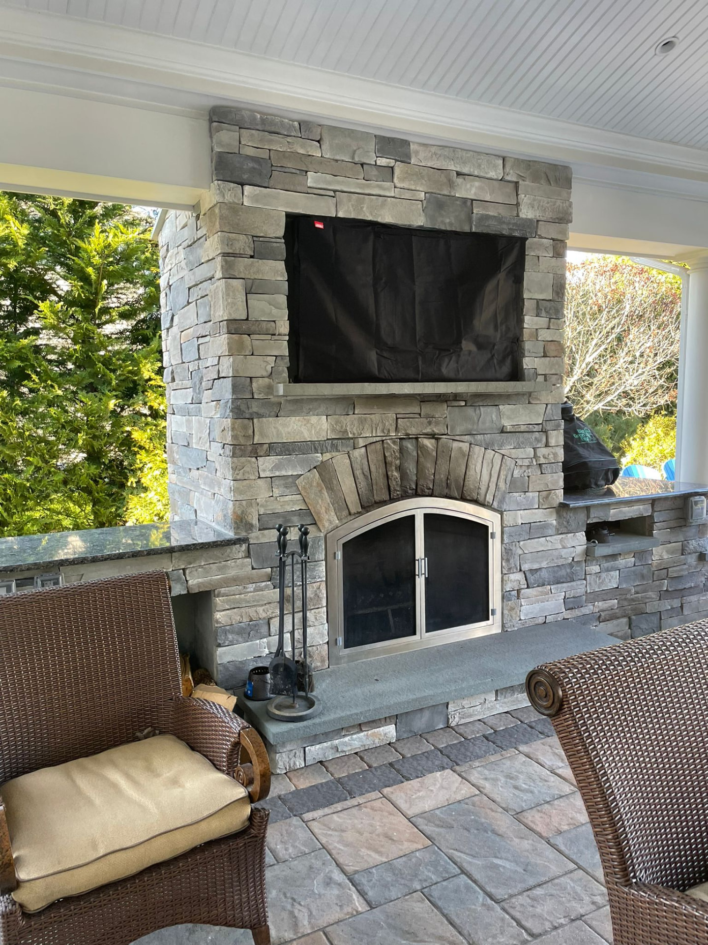 Stacked stone outdoor fireplace & TV wall — East Islip, NY