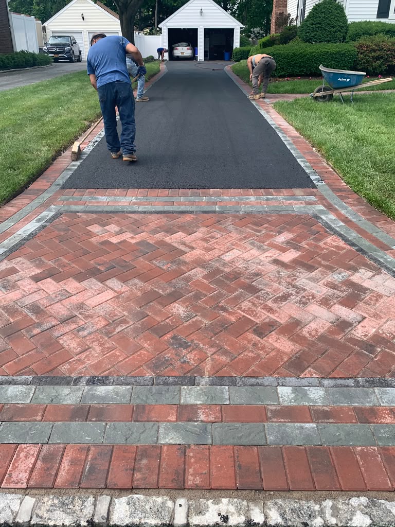 Red brick herringbone drive with charcoal border — Massapequa, NY
