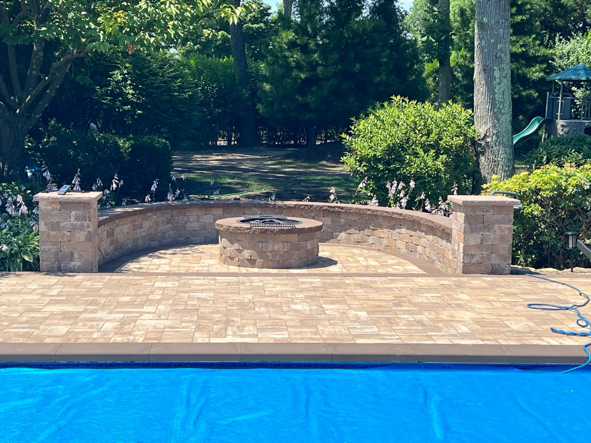 Curved seat wall & fire pit poolside — Hamptons, NY