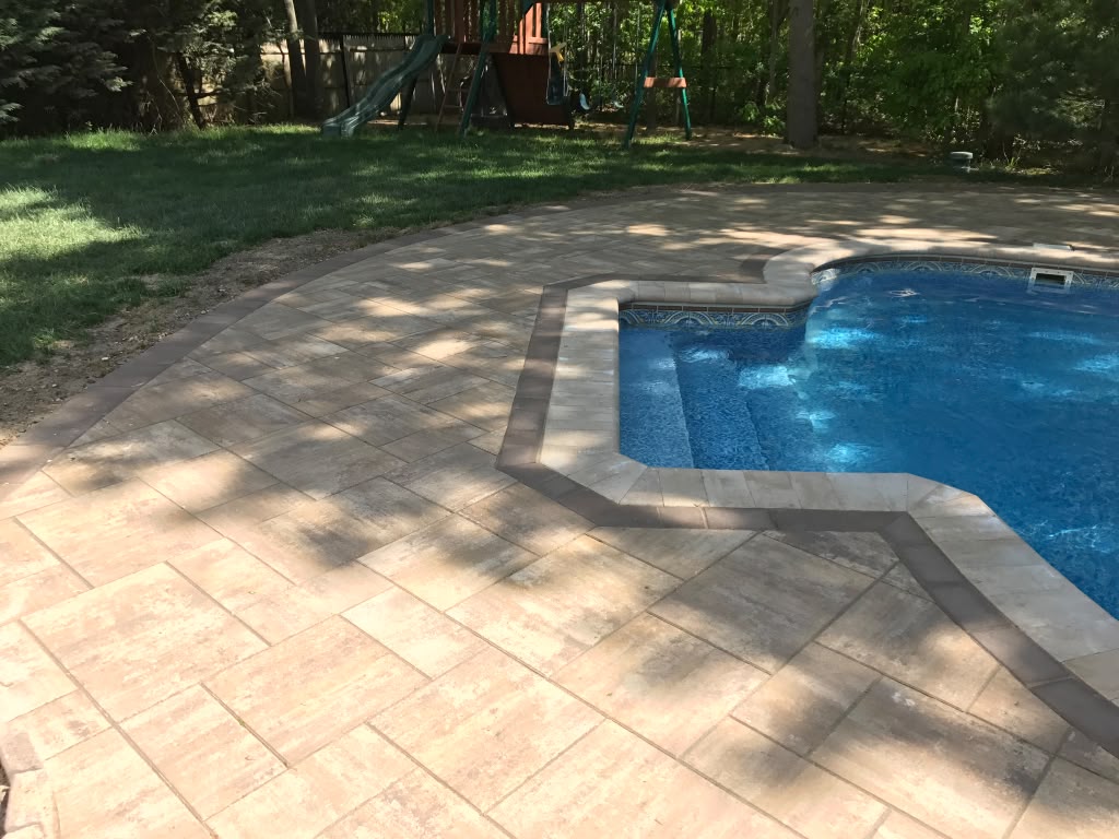 Freeform pool deck with sandstone pavers — Nesconset, NY