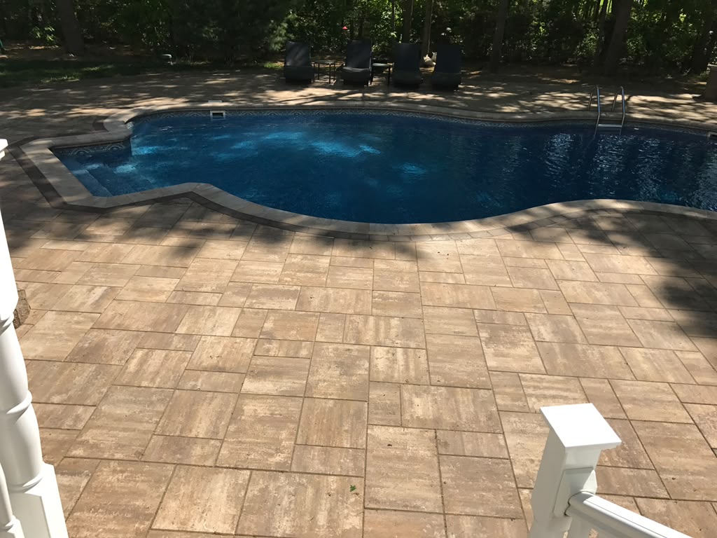 Travertine paver pool deck with contrast coping — Nesconset, NY
